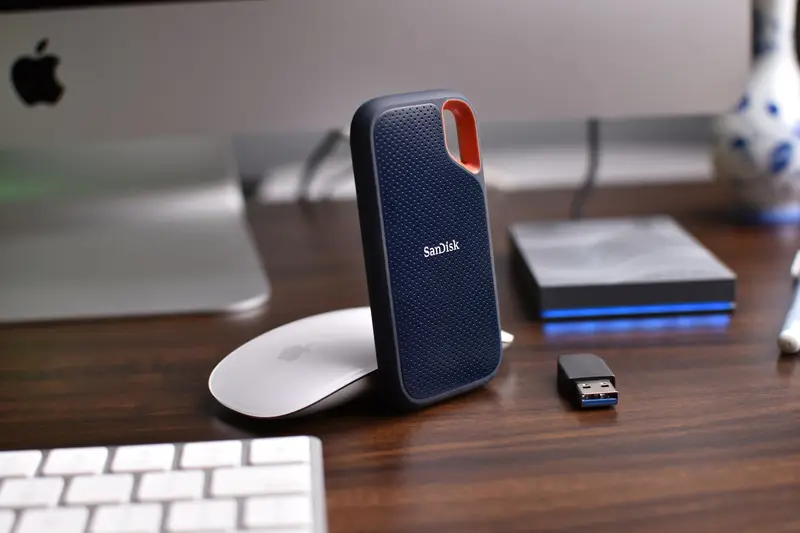 External backup drives on a desk beside a keyboard